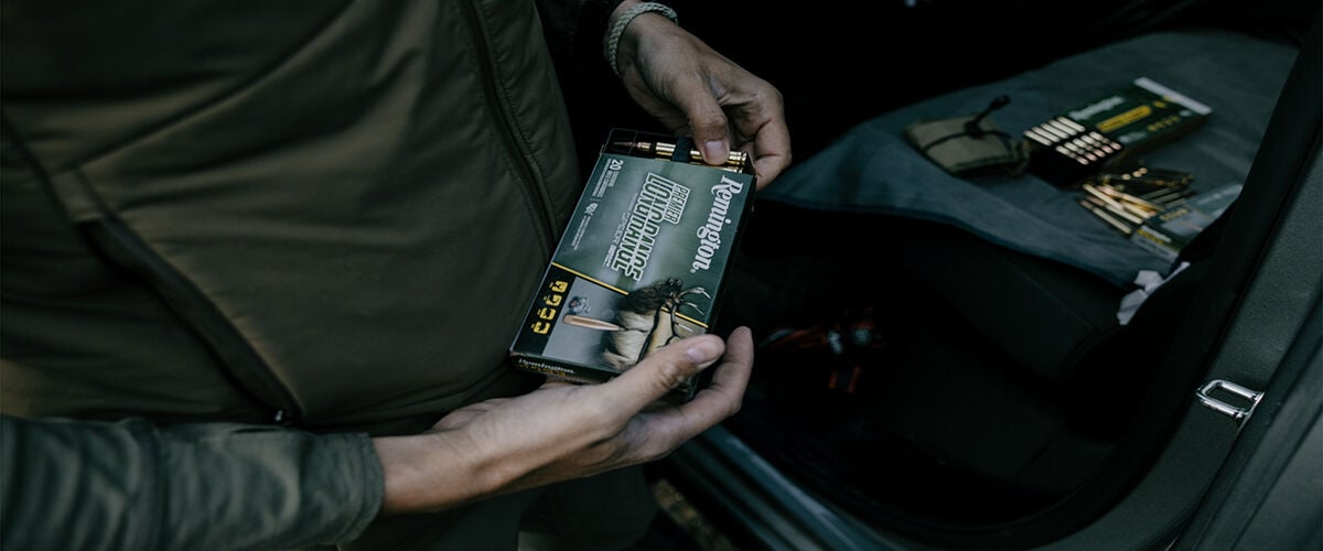 Man holding box of Remington Premier Long Range